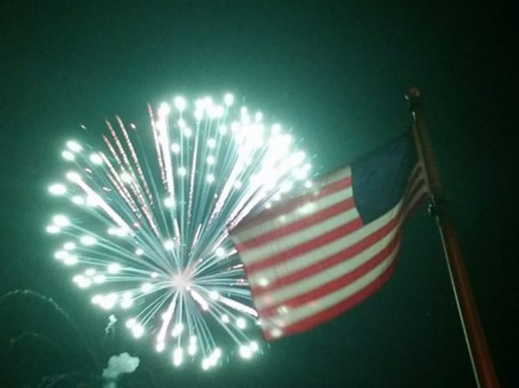 Fireworks above the American Flag