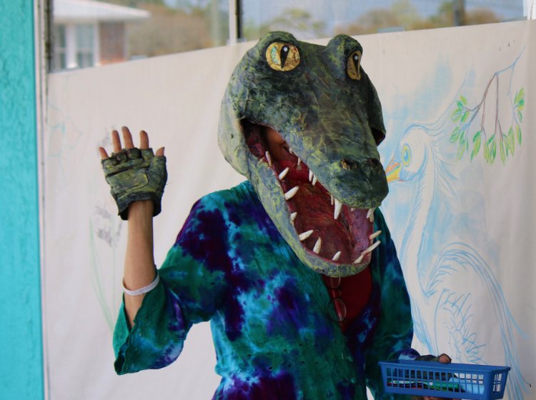 Photo of person wearing an alligator mask