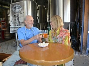Couple enjoying OCBC beer and popcorn