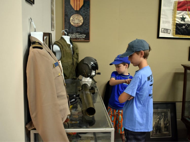 Two boys exploring the WWII Museum in Carrabelle