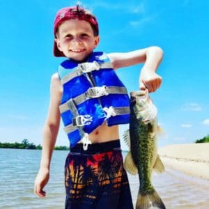 Young Boy holding a Bass on Apalachicola River in Florida