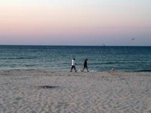 Couple enjoying a walk on the empty beach