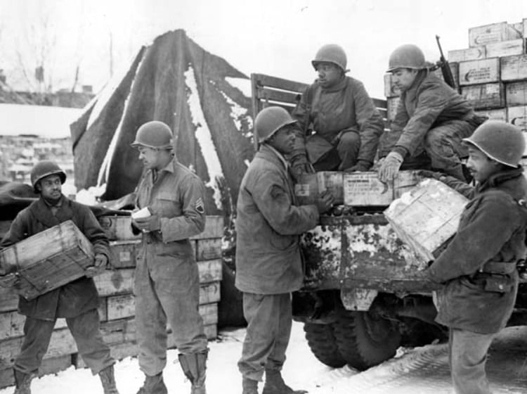 Soldiers load trucks with rations bound for frontline troops