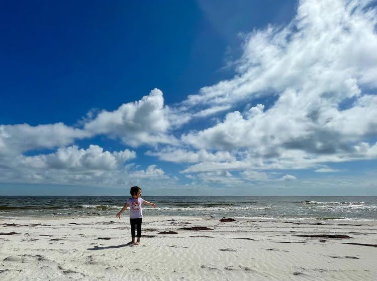Little girl dancing on the beach at St. George Island FL