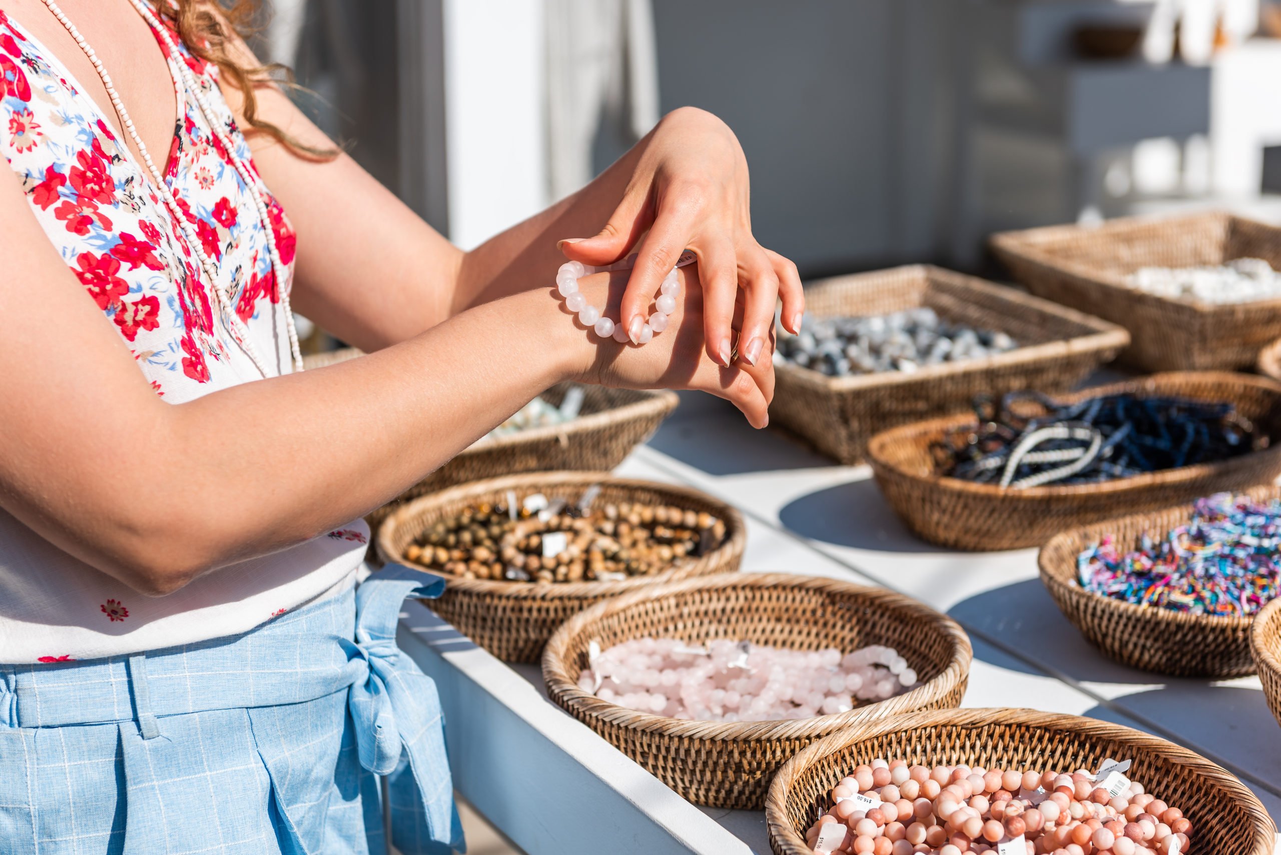 Photo of girl trying on bracelet at an outdoor market
