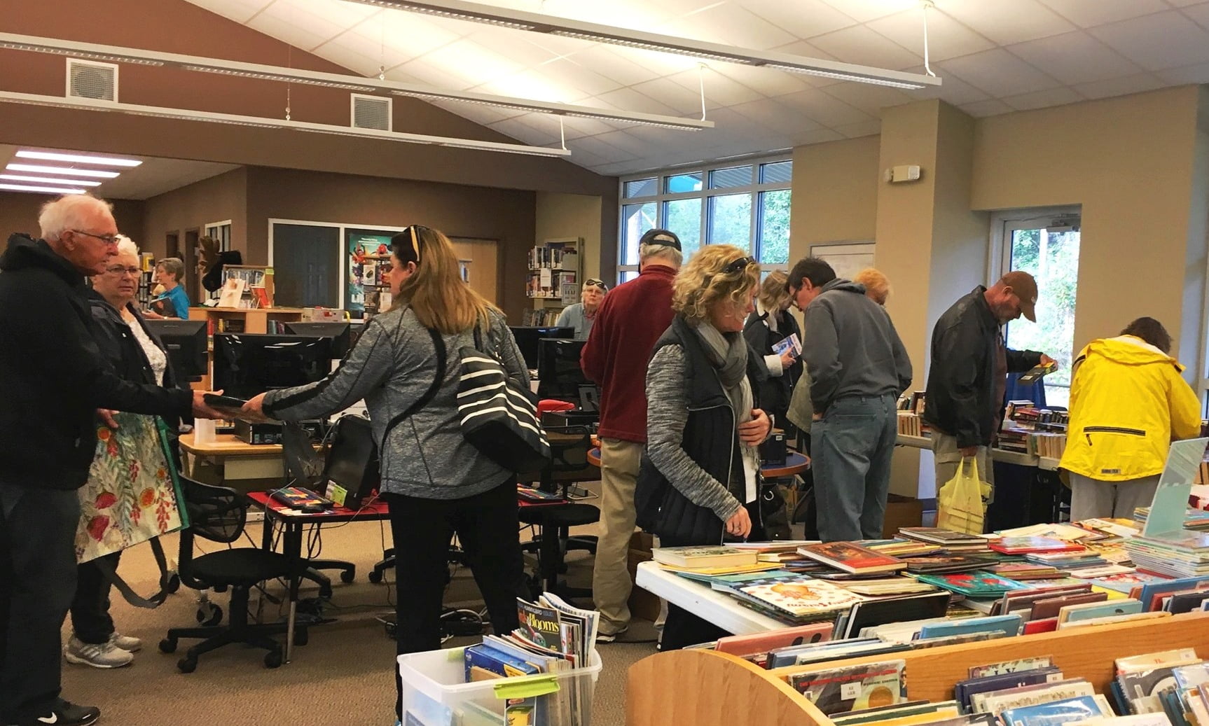 Photo of people looking at used books at the Eastpoint Library