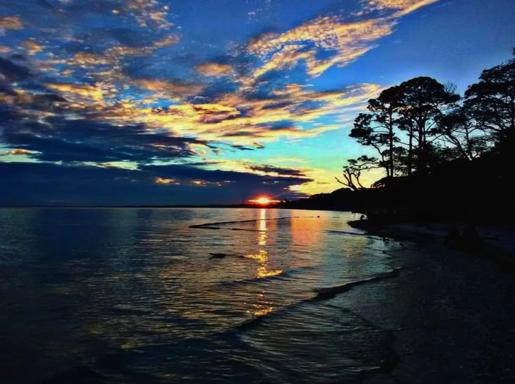 Photo of a sunset over the water on St. George Island