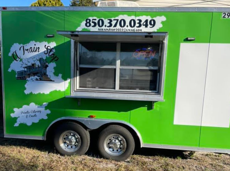 Photo of the "A Train Stop" bright green food truck in Carrabelle