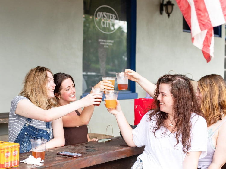 Ladies enjoying local craft beer at Oyster City Brewing in Apalachicola, FL