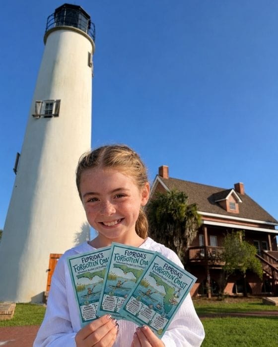 Girl holding Adventure Bucket List Trading Cards